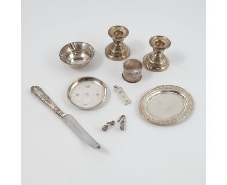 A collection of hallmarked silver, to include, dishes, bowls, an ingot, two napkin holders, a napkin ring, a five bar toast r