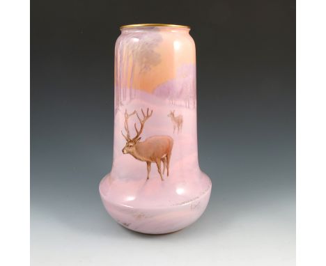 A Royal Worcester vase, decorated all around with a winter scene of a stag and deer in snowy landscape with trees in a pink l