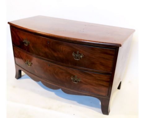 A low mahogany chest, of bow front form, fitted with two long drawers, raised on splayed bracket feet, width 46ins