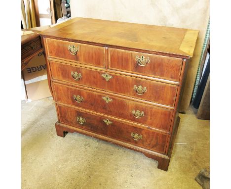 A 19th century walnut chest of drawers, having crossbanded decoration, with two short drawers over three graduated long drawe