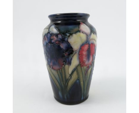 A Moorcroft Pottery vase, decorated in the Orchid pattern to a blue ground, height 5ins Condition report: foot appears to be 