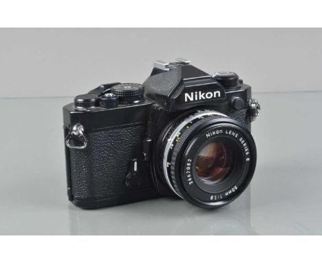 A Nikon FM SLR Camera,  black, serial no 3170915, shutter working, meter responsive, self timer working, body G-VG, light wea