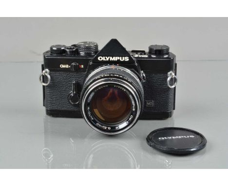 An Olympus OM-2n MD SLR Camera, black, shutter working, responsive in auto, meter responsive, self timer working, body G, bra