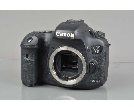 A Canon EOS 7D Mark II DSLR Camera Body,  powers up, shutter working, body G, body G, light wear, with strap, battery and cha