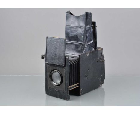 An Adams Minex De Luxe Reflex Camera, shutter jammed, body F, some tears/wear to leatherette, bellows G, viewing hood worn, w