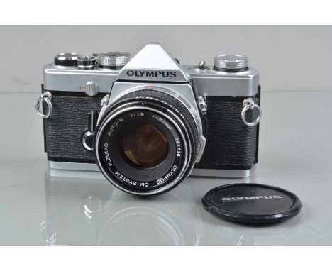 An Olympus OM-1 SLR Camera, shutter working, meter responsive, self timer working, body G, light wear, with F Zuiko 50mm f/1.