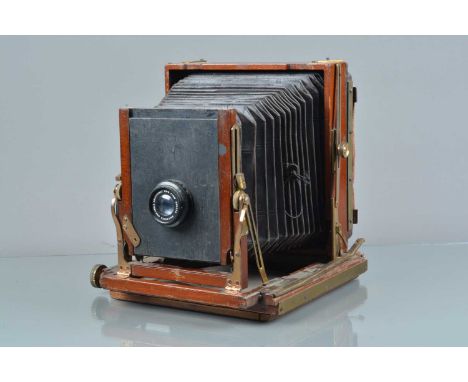 A Kodak Half Plate Mahogany &amp; Brass Camera, back adrift from runners, one runner missing screws, tarnishing to brass, som