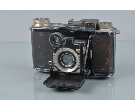 A Zeiss Ikon Super Nettel Rangefinder Folding Camera, model 536/24, shutter sluggish, rangefinder functions, body F, brassing