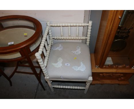 A 19th Century white painted bobbin turned corner chair