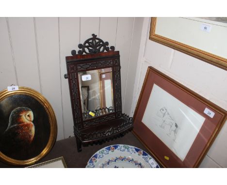 A mahogany fret carved mirrored wall shelf 