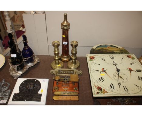 An antique brass and copper fire hose; a pair of Victorian brass push up candlesticks; a brass letter box; a pair of brass le