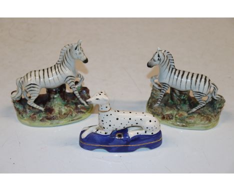 Two Staffordshire models of zebras, and a Staffordshire style quill holder decorated with Dalmatian 