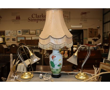 An Oriental ceramic table lamp and shade; and a pair of brass table lamps with frosted shades 