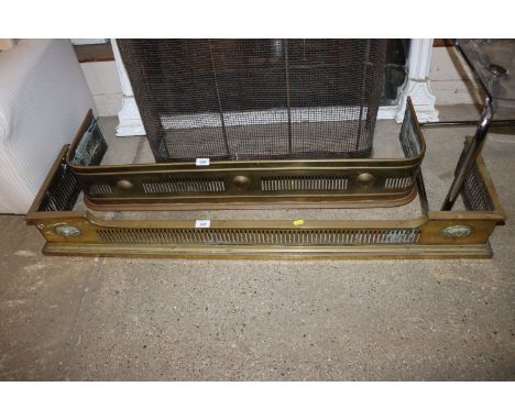 A Victorian brass fender with pierced embossed decoration 