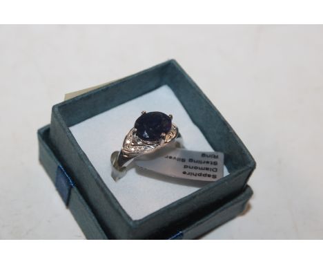 A Sterling silver ring with approx. 10mm x 8mm sapphire and diamonds, ring size R/S