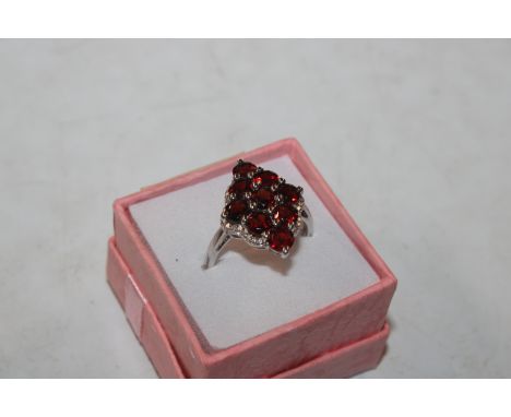 A Sterling silver and garnet set dress ring, ring size R/S