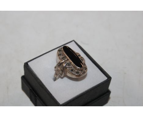 A large Edwardian style Sterling silver and black onyx and marcasite ring, ring size O/P, approx. 6.5gms 