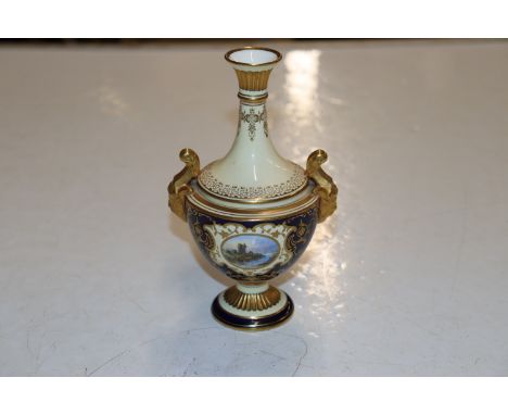 A Coalport porcelain vase flanked by rams head mask handles having gilt heightened decoration, two panels depicting landscape