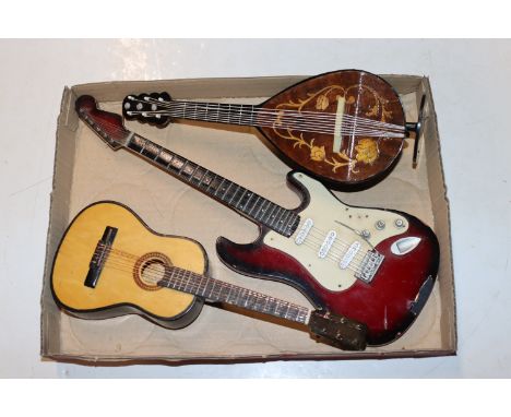 A miniature musical mandolin and two miniature guitars 