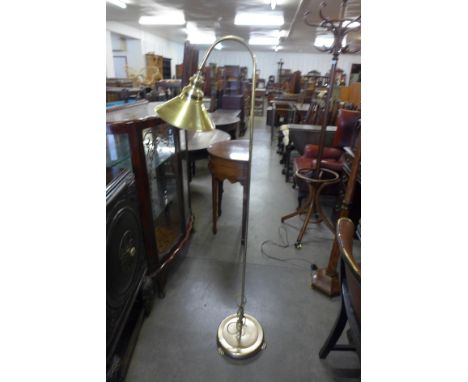 A brass effect floor standing anglepoise lamp 
