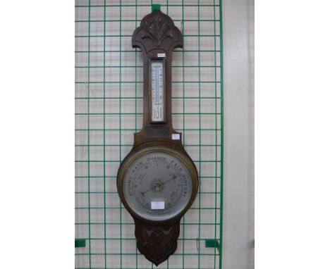 A carved oak aneroid barometer 