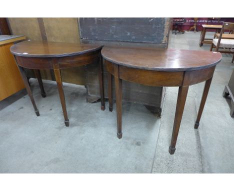 A pair of George IV mahogany demi-lune console tables 
