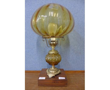 A gilt metal and amber glass table lamp 