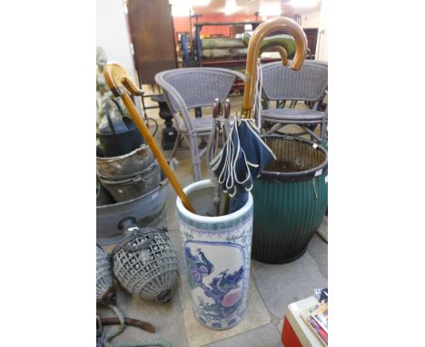 A Chinese porcelain umbrella stand, a shooting stick, walking canes, etc. 