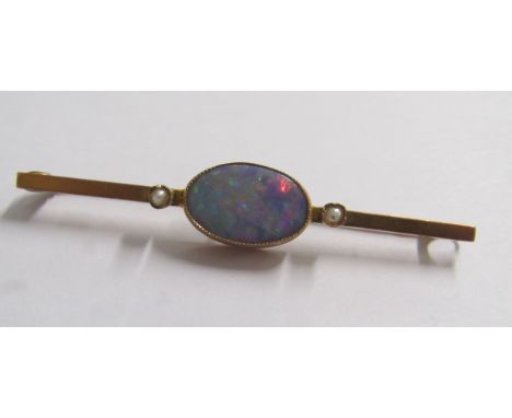 9ct brooch set with single oval fire opal (19mm x 8mm) and 2 seed pearls - total weight 3.8g total length 5.4cm&nbsp;