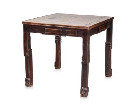 A CHINESE ELM MAHJONG TABLE
The square top set within a mitred frame, above a plain apron fitted with concealed drawers, rais