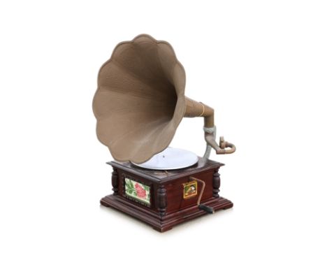 AN HMV WIND UP GRAMOPHONE
With scalloped and etched brass horn, manual crank, turned wooden supports, inset ceramic tile with