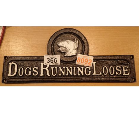 Cast iron Dogs Running Loose sign, L: 32 cm. P&amp;P Group 1 (£14+VAT for the first lot and £1+VAT for subsequent lots) 