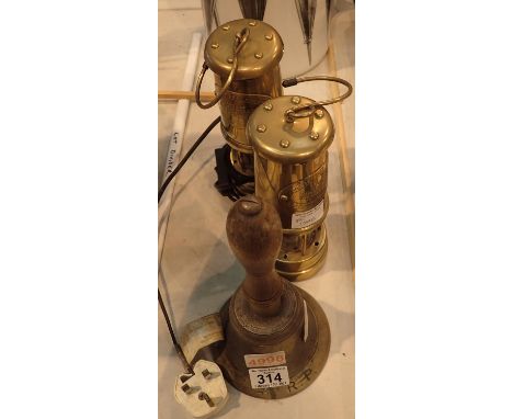 A pair of reproduction miners lamps, one converted to electric, and a vintage brass school bell. Not available for in-house P