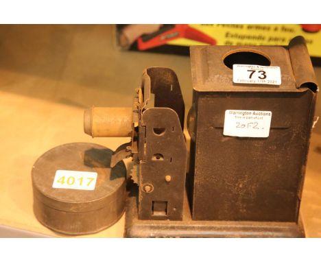 Vintage metal projector and a tin containing a reel of film. P&amp;P Group 2 (£18+VAT for the first lot and £3+VAT for subseq