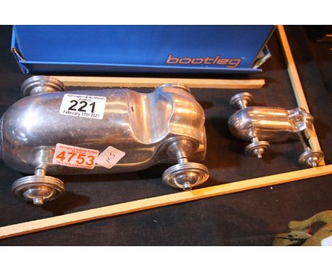 Two Art Deco type cast aluminium racing cars, largest L: 22 cm. P&amp;P Group 2 (£18+VAT for the first lot and £3+VAT for sub