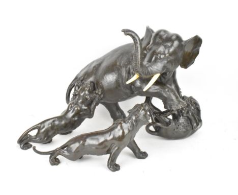 A Japanese Meiji period bronze group modeled as an elephant being attacked by three Siberian tigers, the elephant with a rais