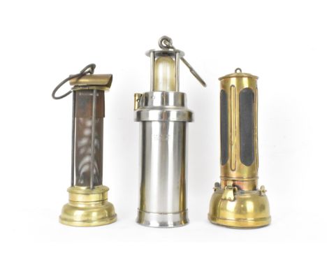 A military issue CEAG miners lamp, engraved with a broad arrow mark, 29cm high excluding handle, together with a Powell &amp;