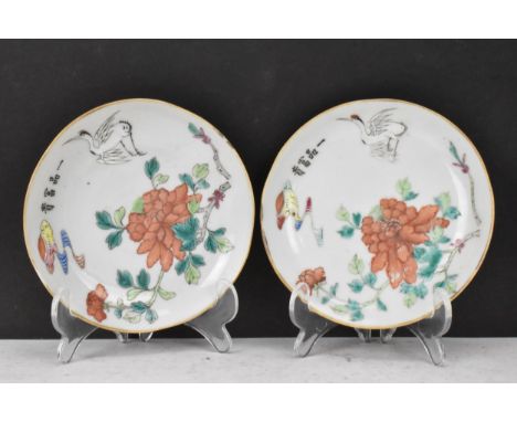 A pair of Chinese late Qing dynasty, Tongzhi porcelain famille rose dishes, each decorated with a crane in flight and chrysan