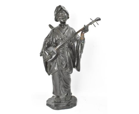 A Japanese Meiji period bronze figure of a bijin musician, wearing a kimono and playing a shamisen with a large plectrum, on 