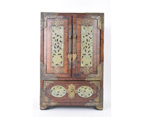 A Chinese 20th century hardwood and jade panelled jewellery cabinet box, the cabinet having twin doors set with carved jade p