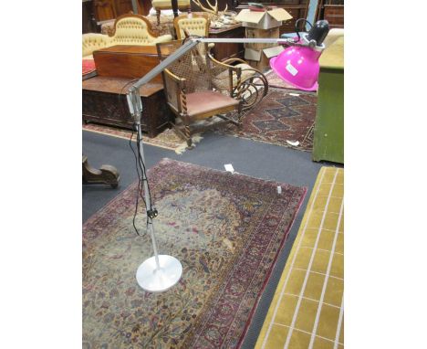 A modern Anglepoise standard lamp with pink shade  
