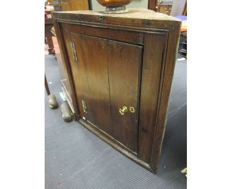 A small 18th century oak corner cupboard with single panel door  