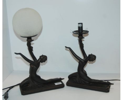 A pair of lady lamps and a further ball shaped lamp Condition Report:Available upon request