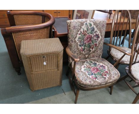 A mid 20th century Ercol armchair and a Lloyd loom laundry hamper (2) Condition Report:Available upon request