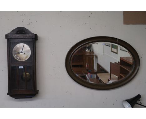 A 20th century oak cased wall clock and an oval wall mirror (2) Condition Report:Available upon request