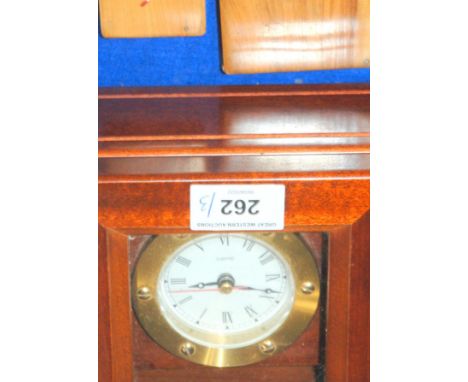 A quarts clock with a treen cigarette case and vesta Condition Report:Not available for this lot.