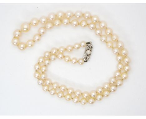 A string of pearls with a 9ct white gold pearl and diamond set clasp, largest pearl approx 8.3mm, length 56cm Condition Repor