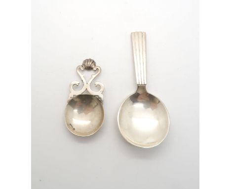 A Scottish silver caddy spoon by Isle of Mull Silver Co, marked to bowl, with a shell capped pierced scroll handle, and a Geo