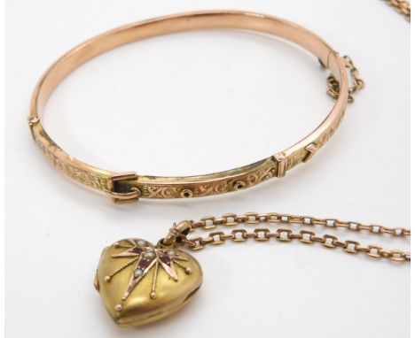 A 9ct gold buckle shaped bangle, and a yellow metal red gem and pearl set heart shaped locket and a 9ct vintage chain, weight
