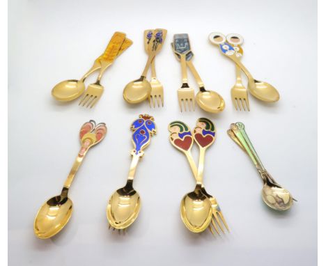 A collection of Anton Michelsen danish silver gilt and enamel christmas spoons and forks, 1967, 68, 69, 66, 73 &amp; 74, a 19
